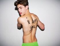 top runway model francisco lachowski shirtless wearing lime green shorts with i love you written in marker on his back
