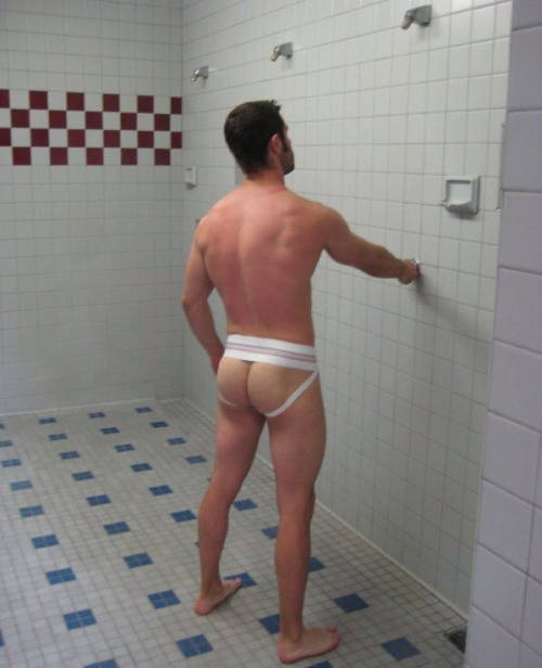 Athlete Standing in the Shower in a Jockstrap