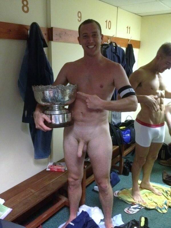 Naked Guy in a Changroom Holds his Trophy and Points to it with a Boner