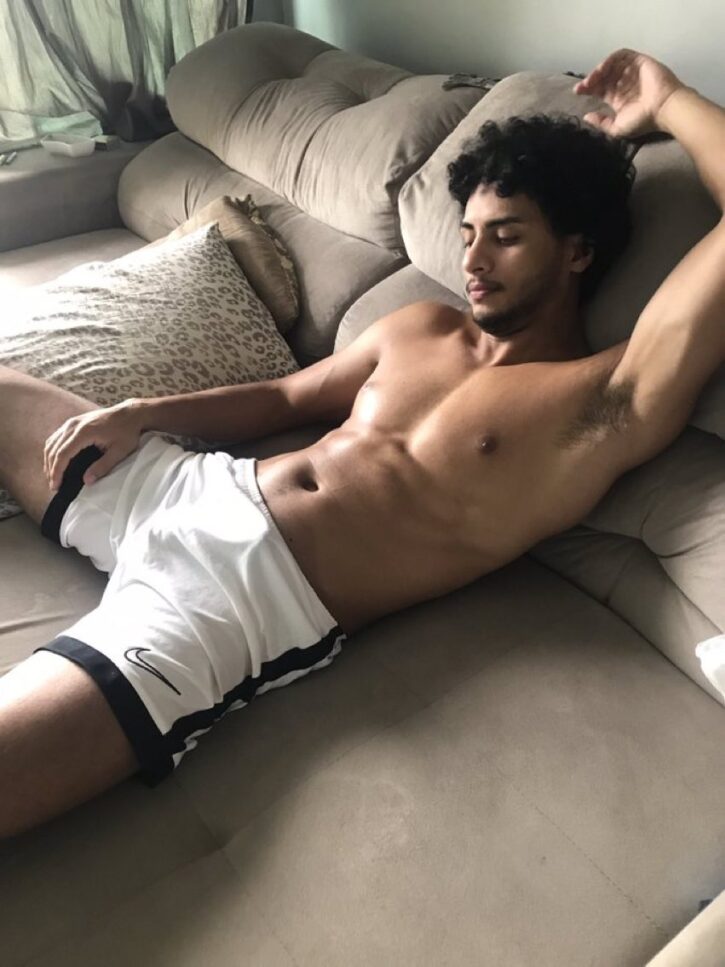Benny lying down on the sofa in white nike shorts shirtless ready to stroke his horny cock