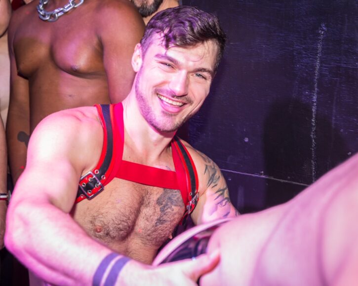 Smiling gay male fucking at UK sex party