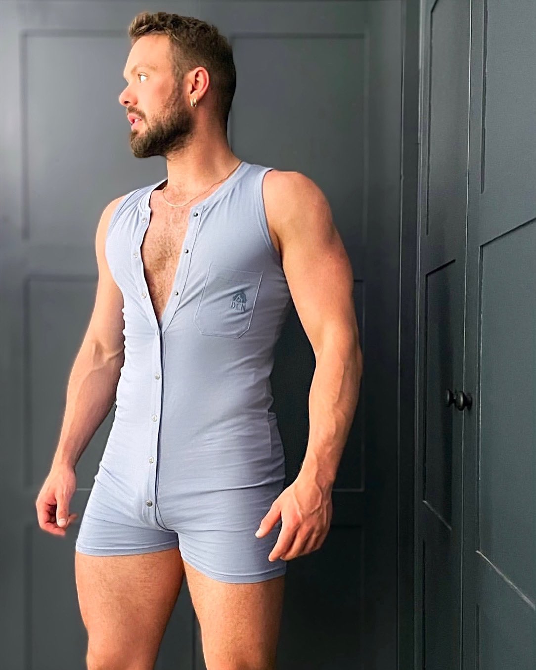gay male porn star wearing a light blue short union suit for den loungewear