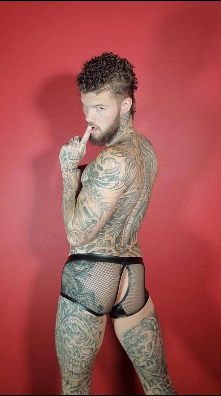 tattooed muscle hunk wearing mesh underwear with a butt slit ready for gay anal by Debonair