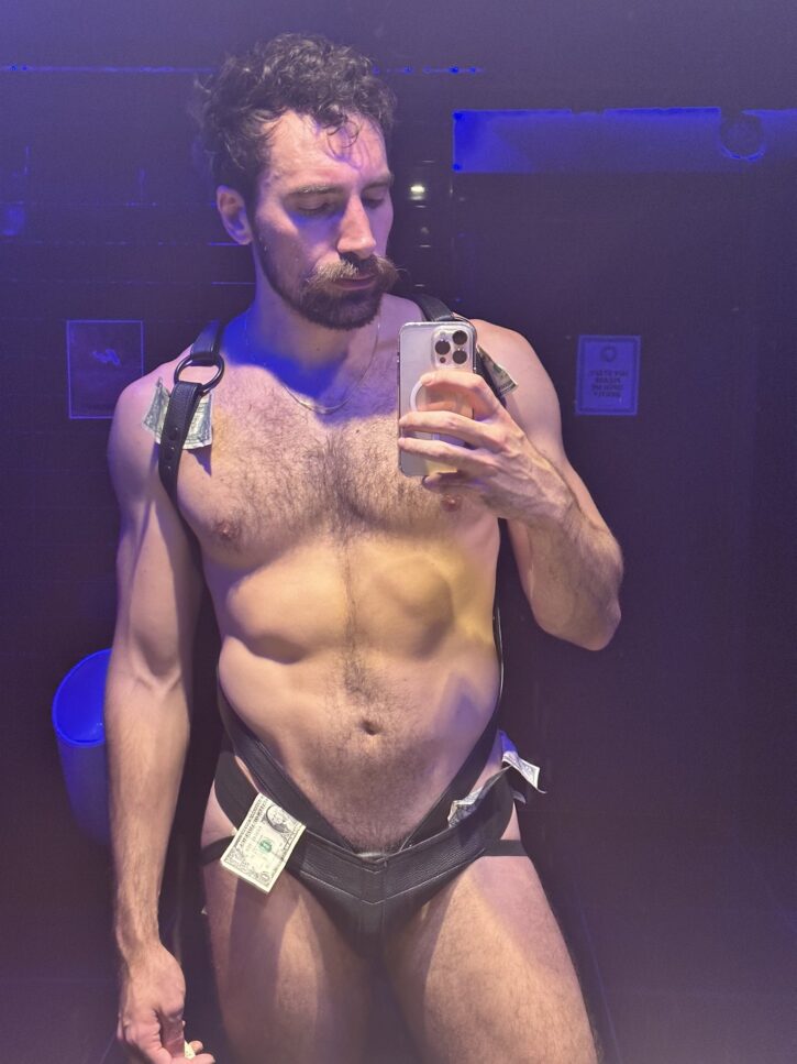 gay leather muscle daddy gogo dancer with ones hanging out taking selfie