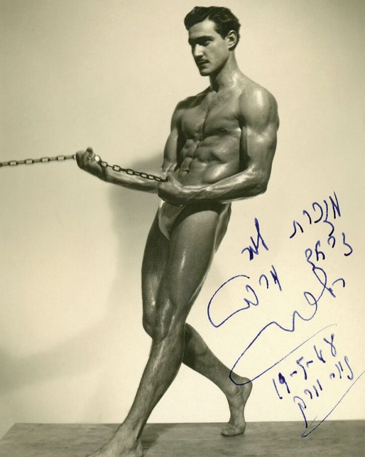 vintage gay muscle posing oiled up with chains