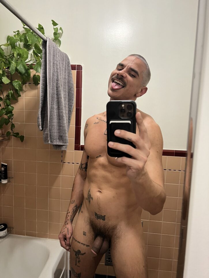 gay tattoo hipster smiling naked with dick out to camera