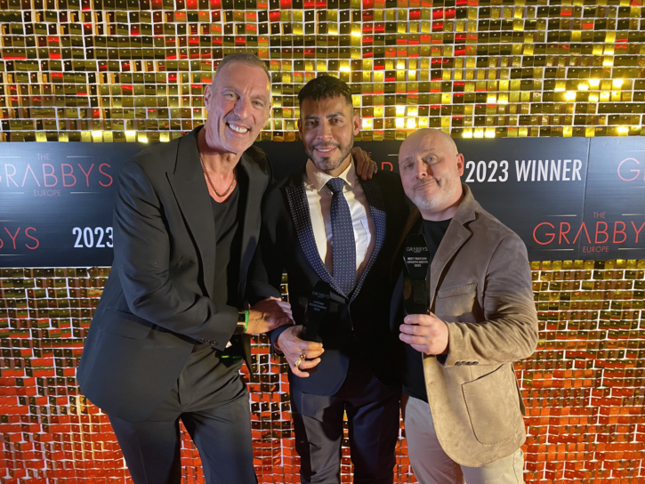 viktor rom posing with two winners at the europe grabbys 2023 