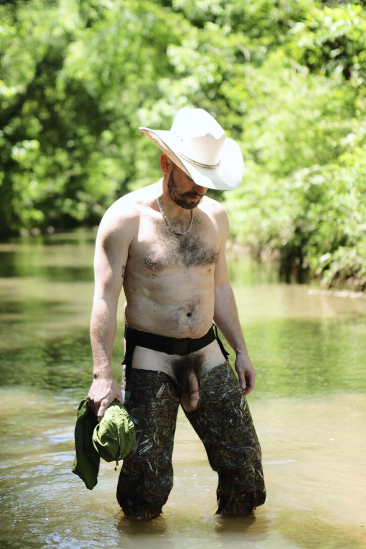 hairy muscle daddy wearing chaps half naked in the river