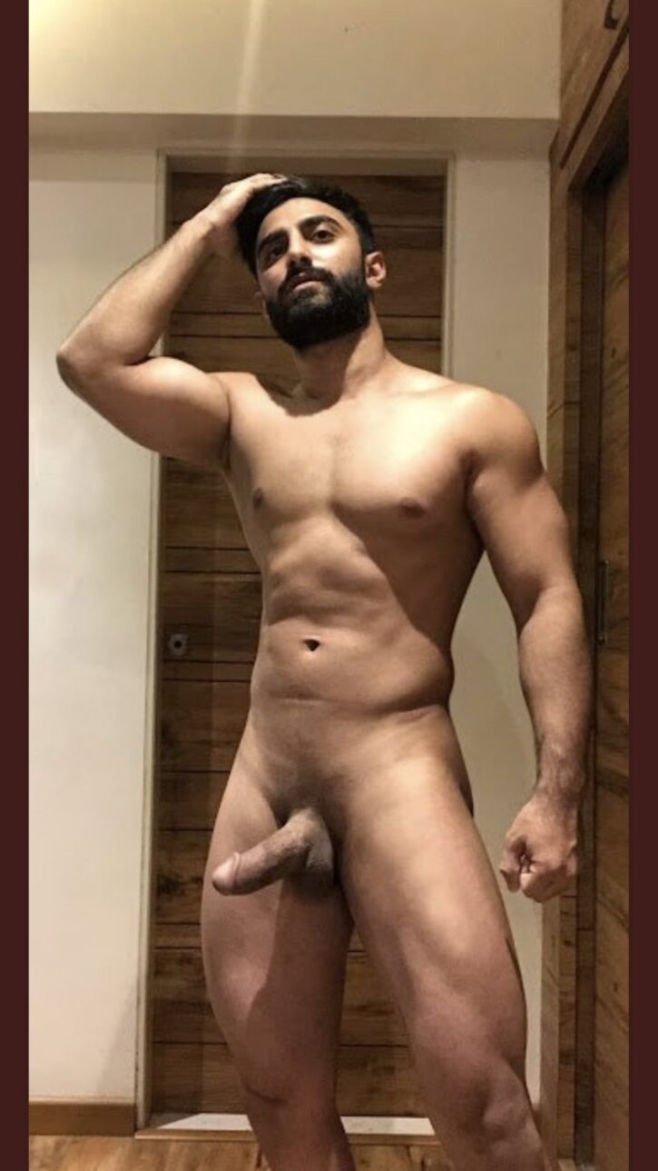 naked gay stud posing with half-erect cock 