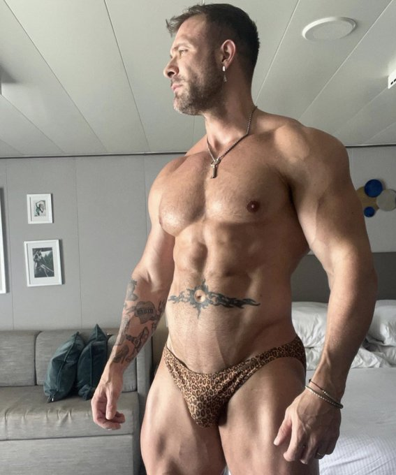 gay muscle stud Austin Wolf posing for a selfie wearing a leopard print bikini bottom