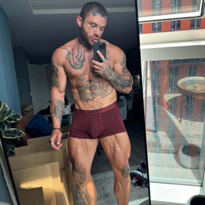 Joel Hart wearing red boxer briefs taking an iphone mirror selfie showing off his hot abs and tattooed chest