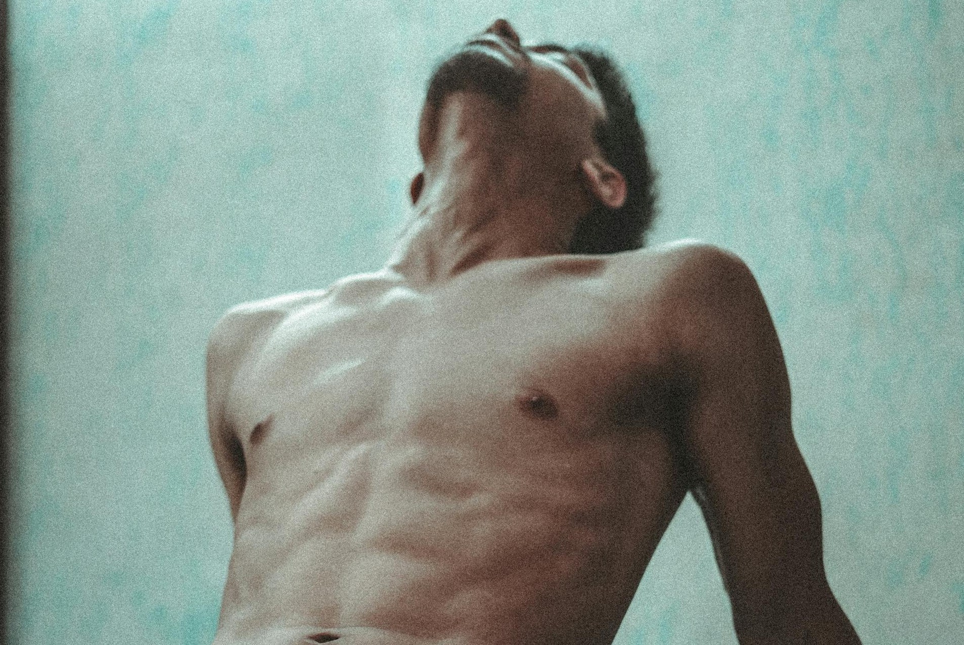 shirtless gay male throwing his head back in pleasure via pexels Photo by Yogendra Singh