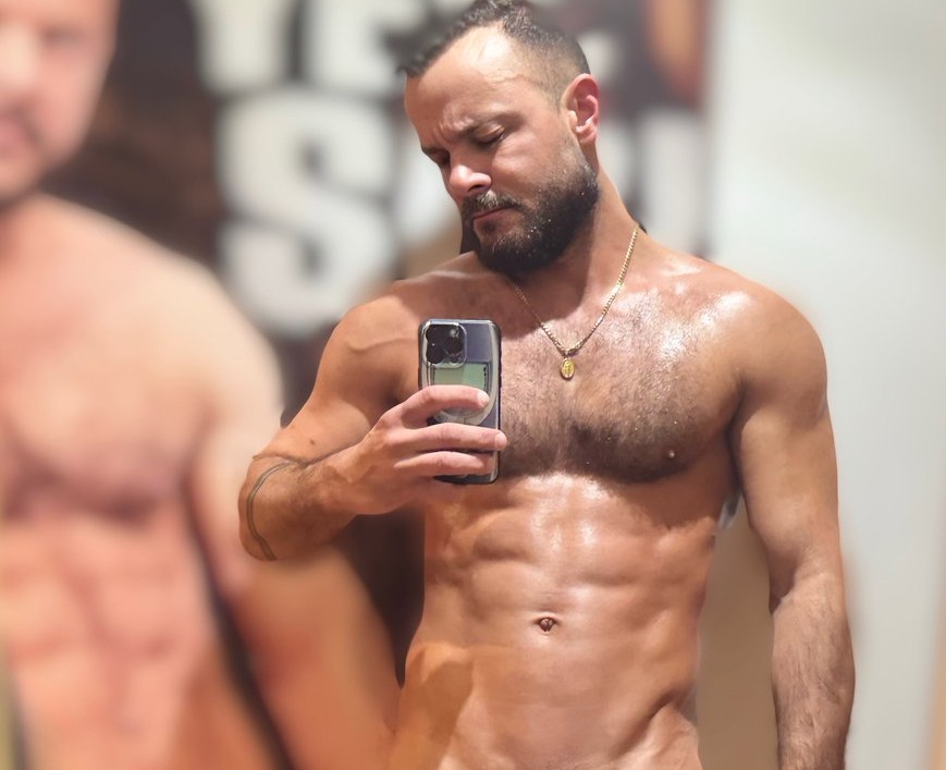 gay xxx onlyfans gay porn creator Jake Sir Peter naked taking an iphone mirror selfie showing off his half erect dick in a cock ring showing off his muscled body and hairy chest