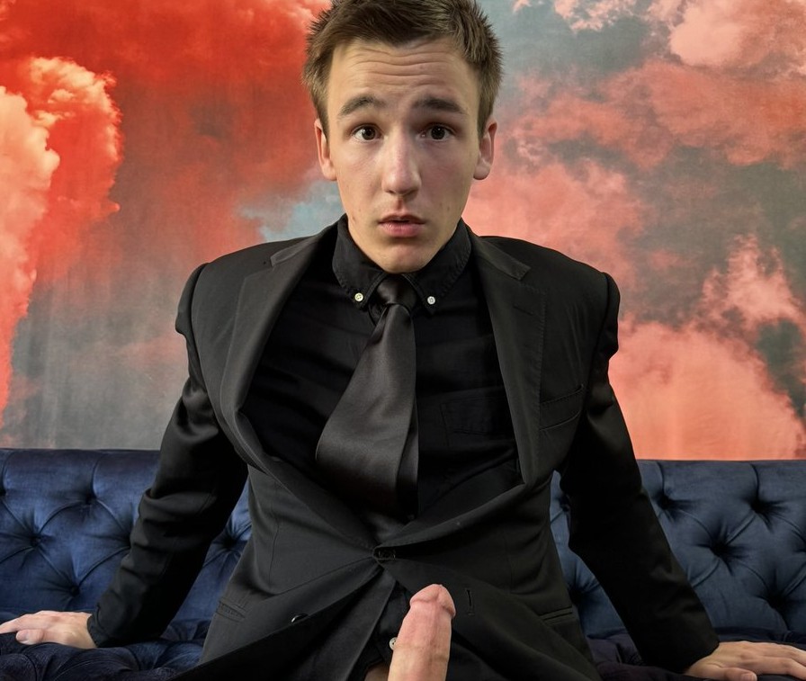 gay xxx onlyfans creator and horny twink zac steele posing in black suit top and suit jacket with no pants in sock garters showing off suit fetish with his thick cut dick hard and ready to jerk