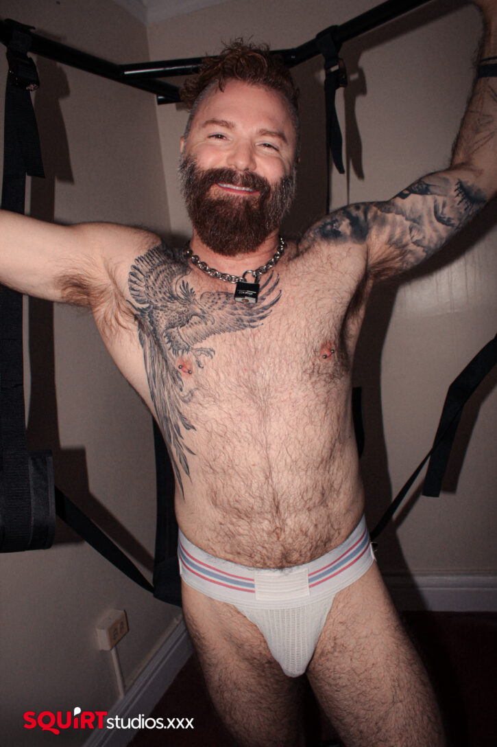 smiling horny gay daddy Rob Montana wearing white dirty jockstrap for sniffing fetish ready to get in gay sex sling for solo jerkoff via gay porn studio squirt studios