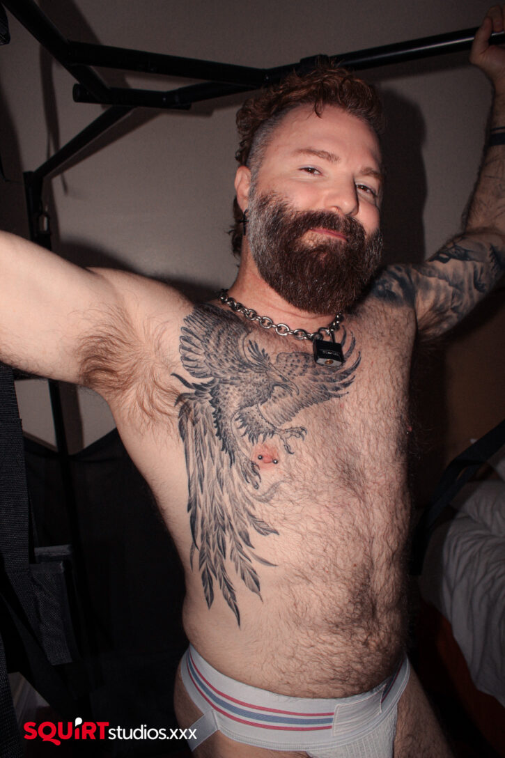 gay xxx porn actor and hairy porn daddy Rob Montana flexing his muscles and showing off his hairy muscle chest for porn studio squirt studios