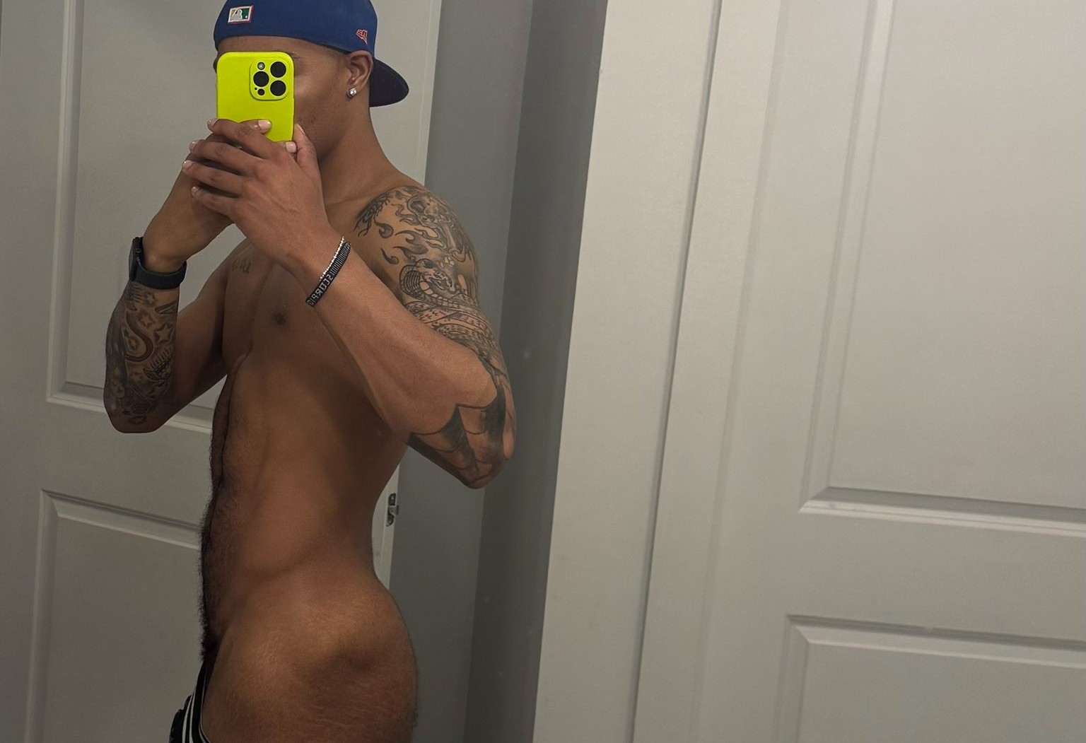 gay xxx onlyfans content creator 404champ posing shirtless in the mirror in an iphone mirror selfie showing off his naked gay bubble butt
