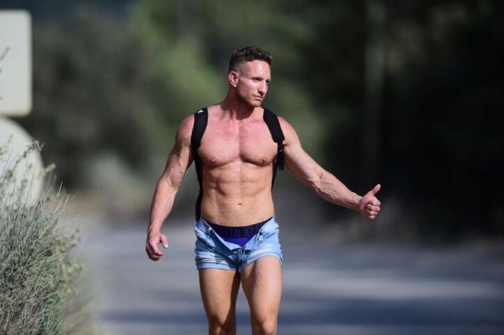gay xxx porn and onlyfans creator Magnus Loki hitchhiking bareback in denim shorts cutoffs showing bulge outdoors