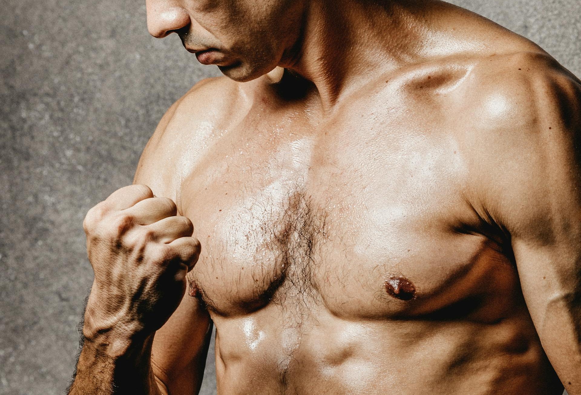 gay shirtless male greased up ready to gay fist in hot horny gay hookup via pexel by Jonathan Borba
