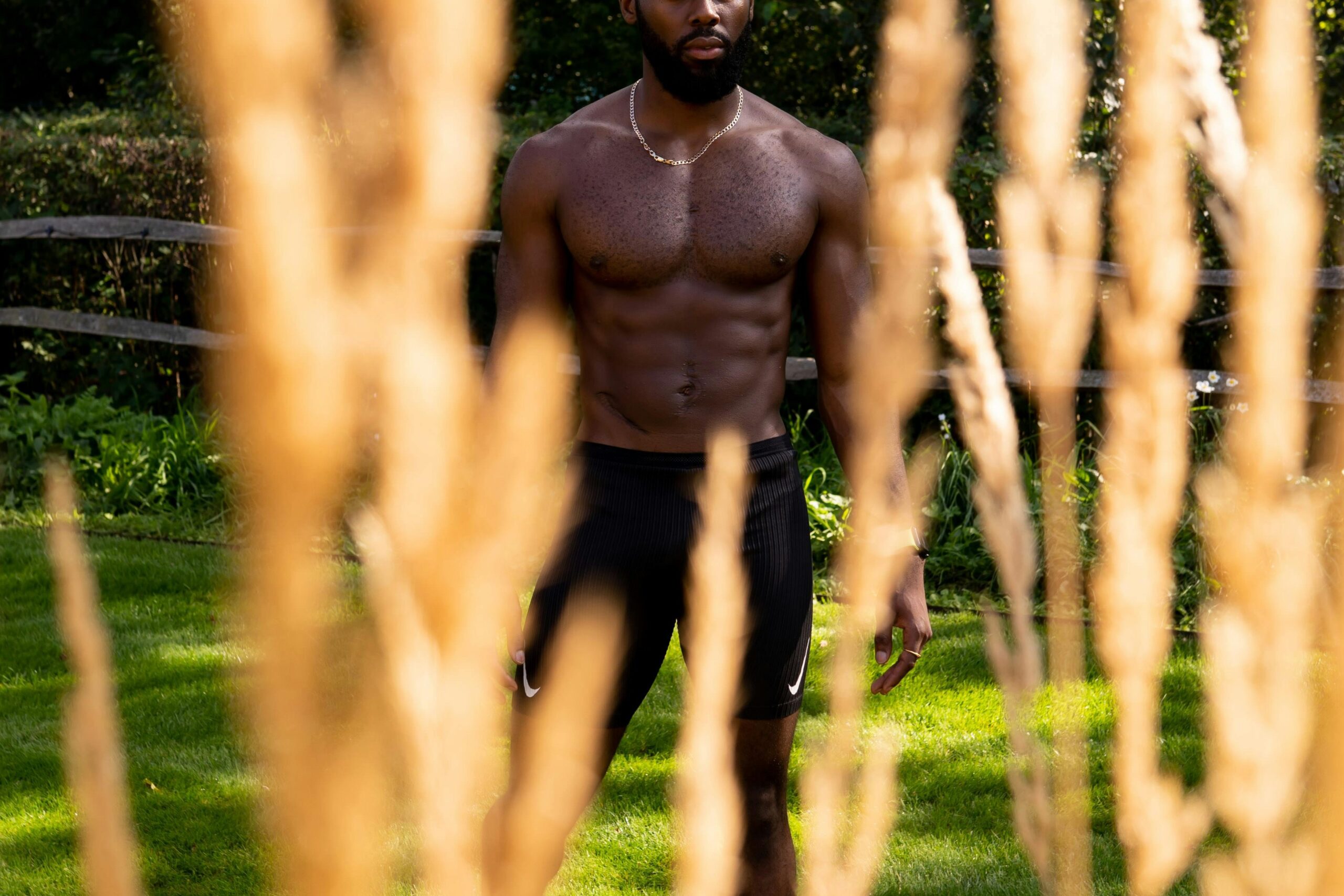 gay shirtless male hanging out on the lawn looking for anonymous gay cruising spots in bogota university Photo by Spencer Cooper via Pexels