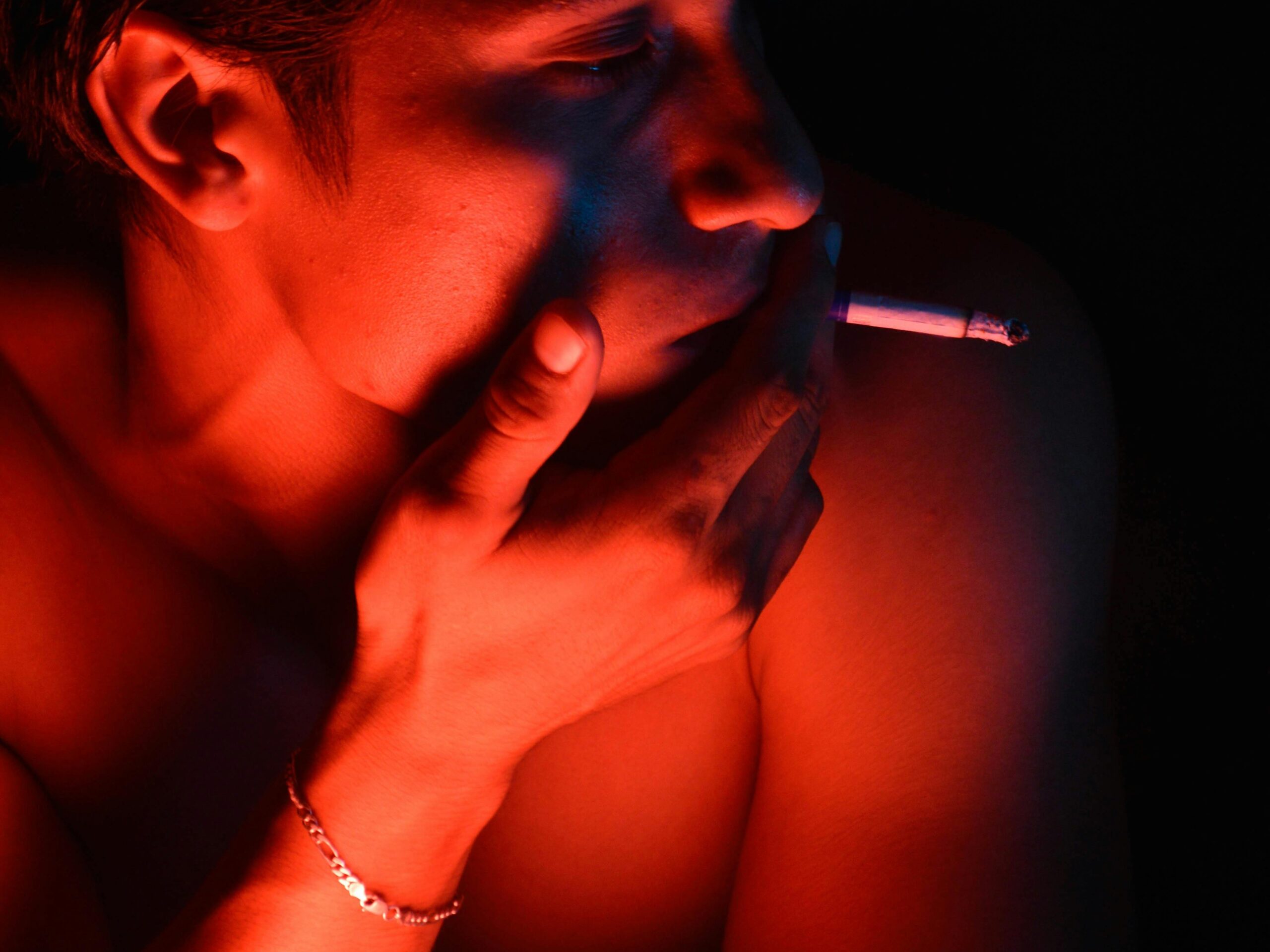 gay shirtless male smoking in the dark sex sauna club in baraquille colombia Photo by Baltazar Vera Gutiérrez