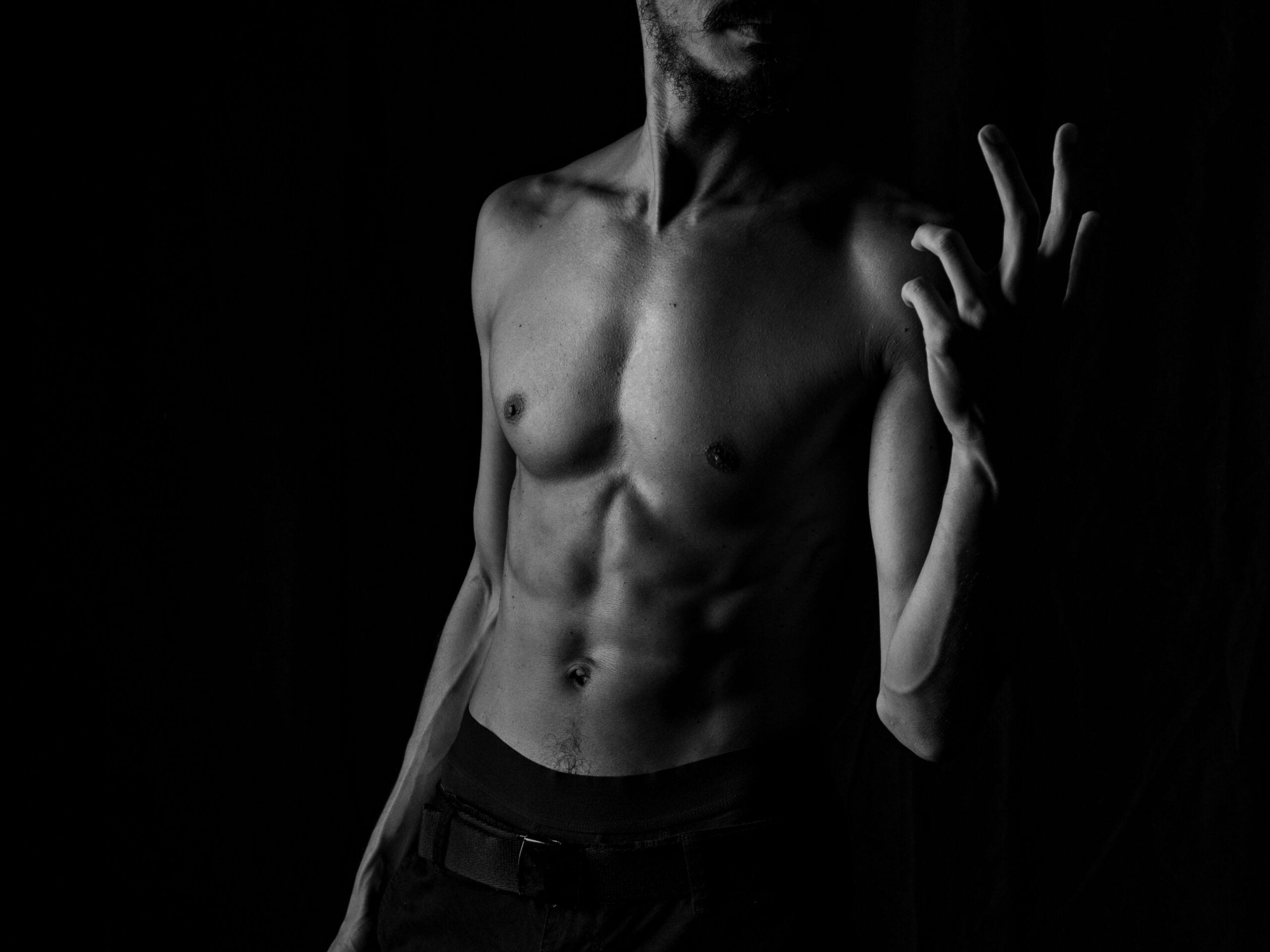 gay shirtless male standing in the corner of a dark gay basement part for DC washington pride photo by MAG Photography via Pexels