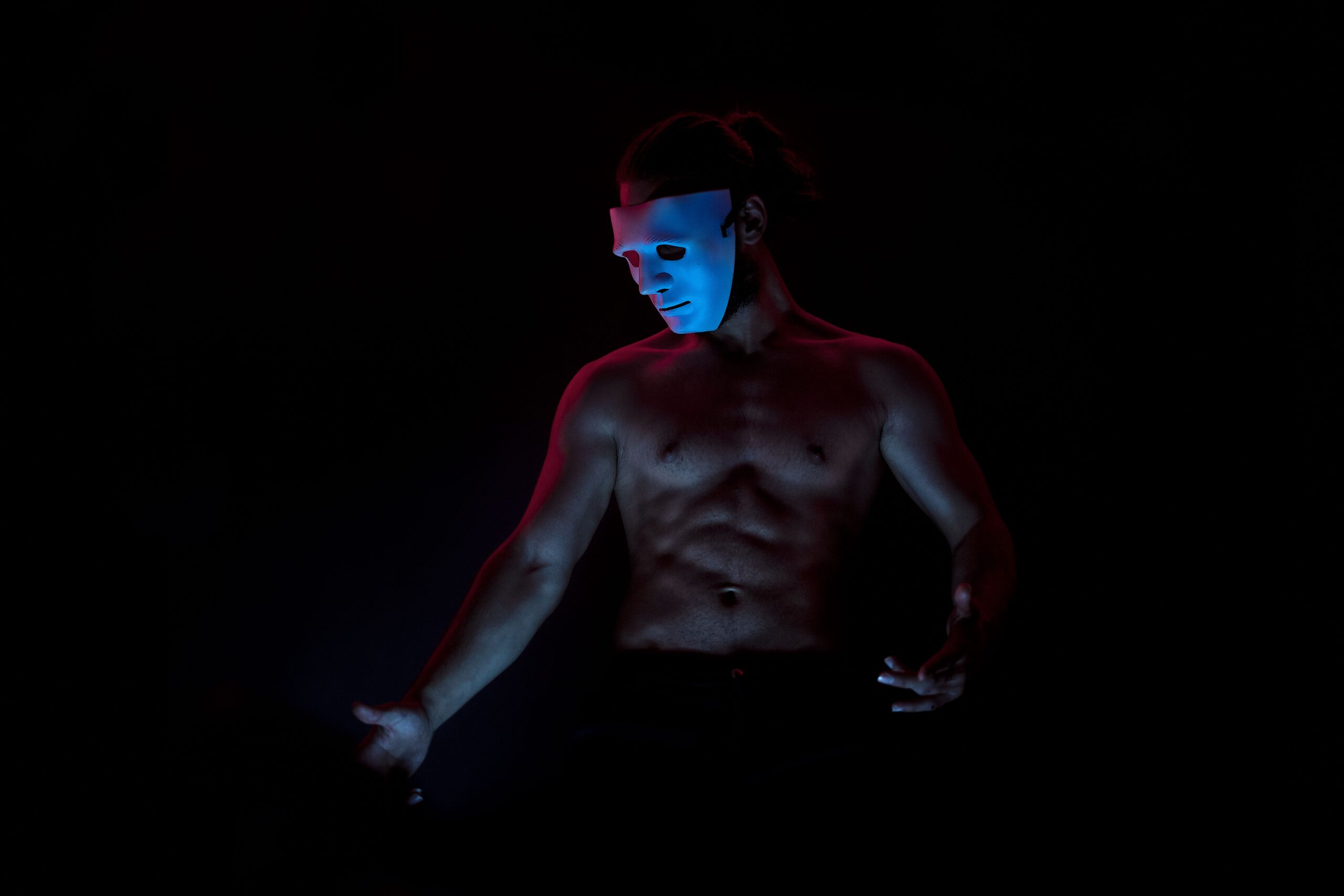 gay sexy shirtless male exploring halloween nightlife wearing scary anon mask for halloween in weho west hollywood los angeles california USA